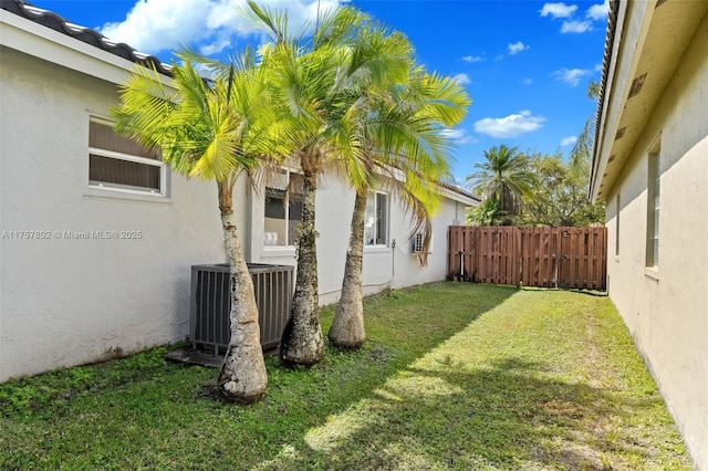 view of yard featuring cooling unit and fence