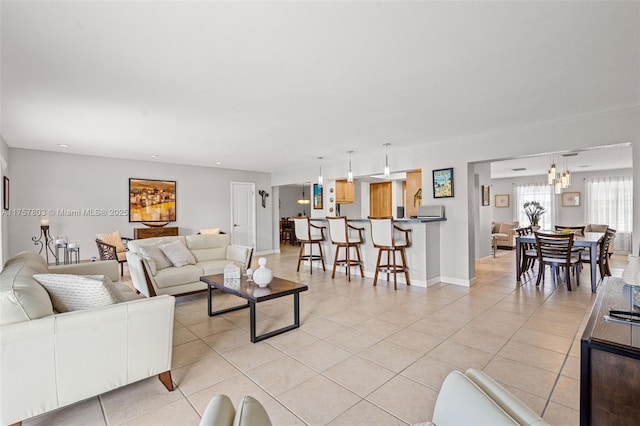 living area with light tile patterned floors and baseboards