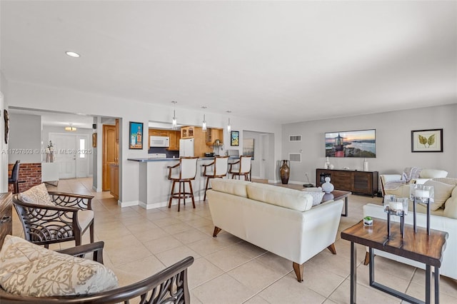 living room featuring recessed lighting, light tile patterned floors, baseboards, and visible vents