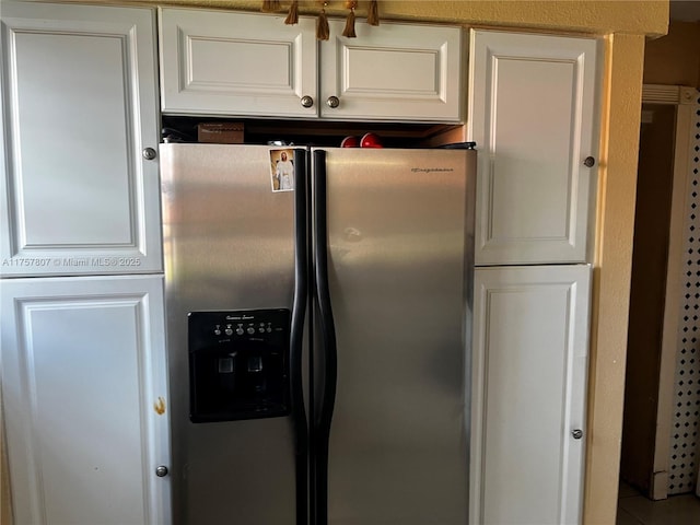 kitchen with white cabinetry and stainless steel refrigerator with ice dispenser