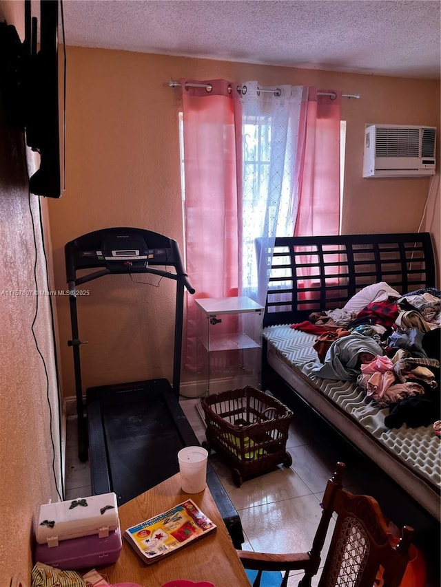 tiled bedroom featuring a textured ceiling and a wall mounted AC