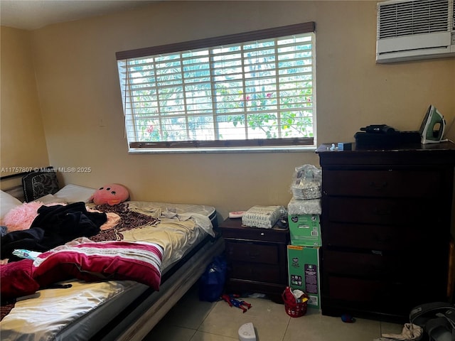 bedroom with tile patterned flooring and a wall mounted air conditioner