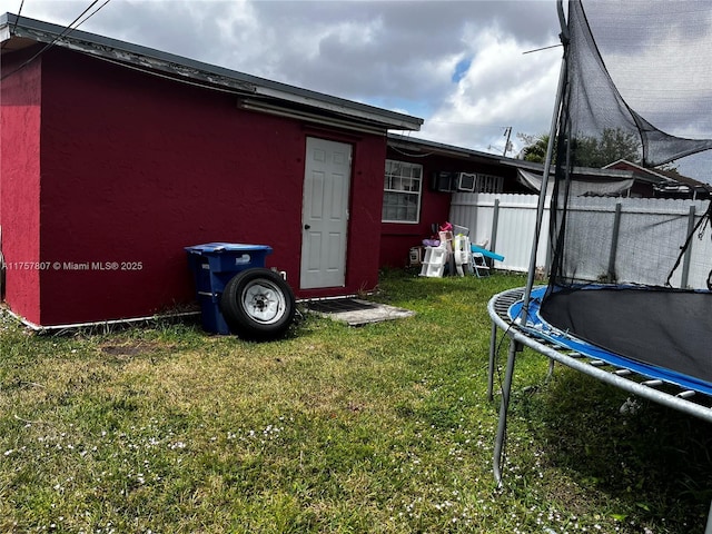 exterior space with a trampoline and fence