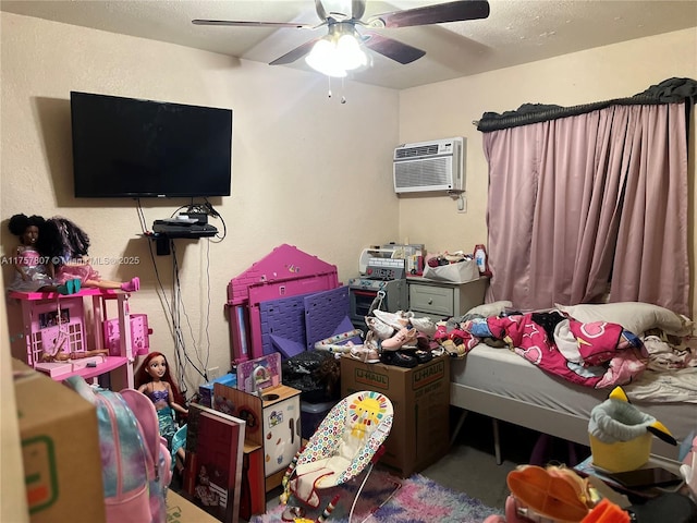 bedroom featuring a ceiling fan, a wall unit AC, and a textured wall