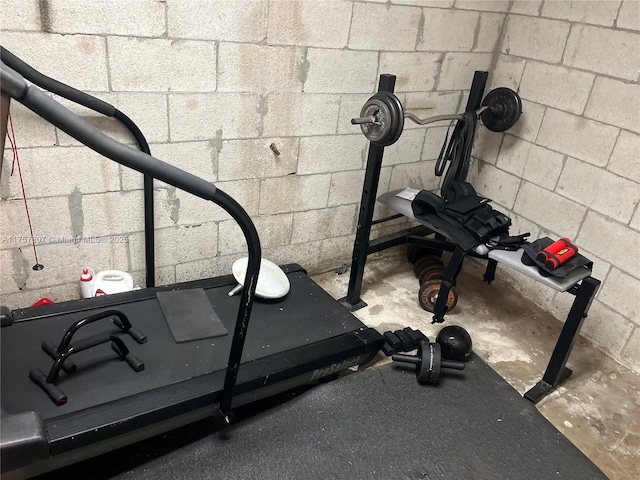 workout room featuring concrete block wall