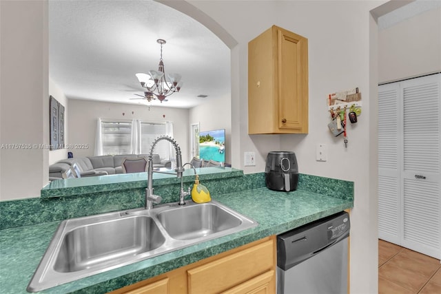 kitchen with a sink, dishwasher, and light brown cabinetry