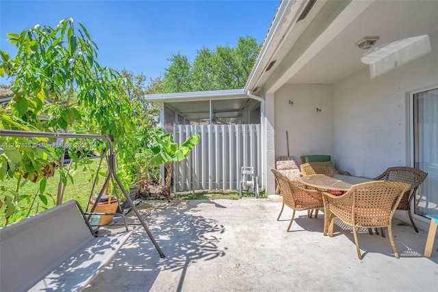 view of patio featuring a sunroom