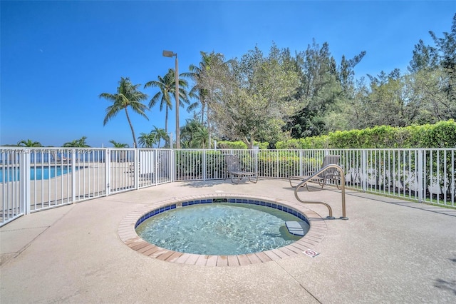 view of pool with a pool, a patio area, and fence