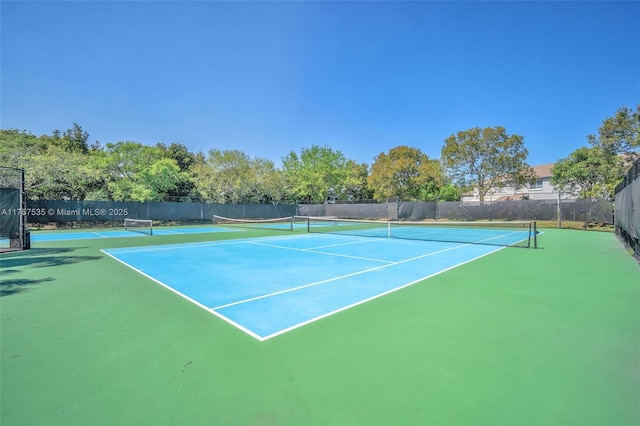 view of tennis court with fence