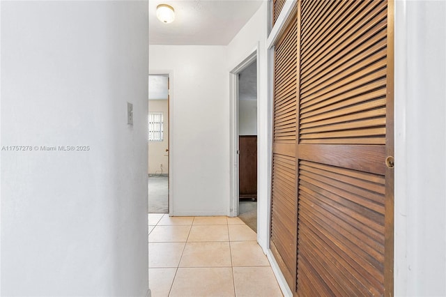 hall featuring light tile patterned floors