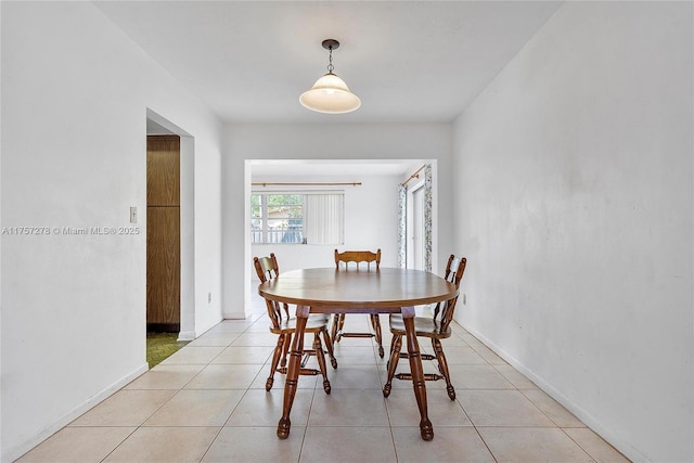 dining area featuring baseboards and light tile patterned flooring