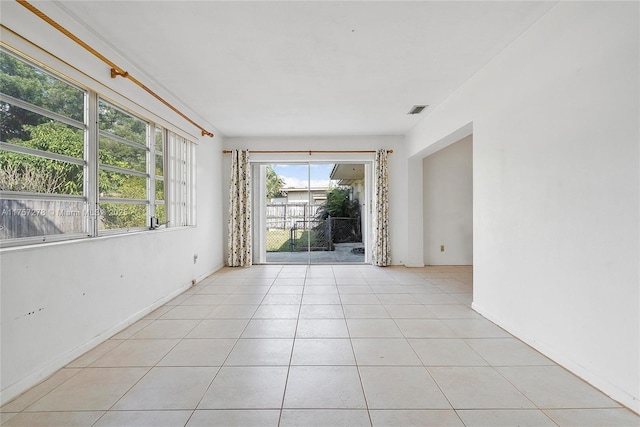 unfurnished room with light tile patterned floors and visible vents