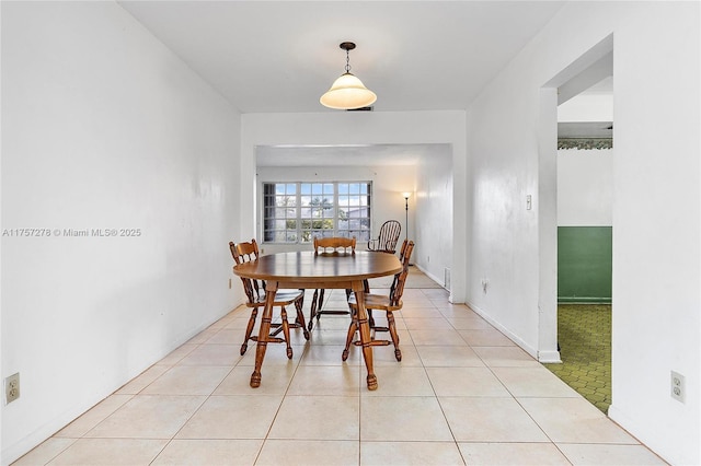 dining area with light tile patterned floors