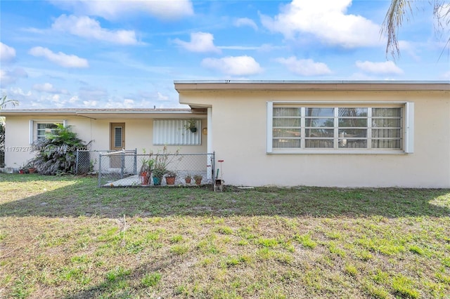 view of front of home featuring a front lawn and stucco siding