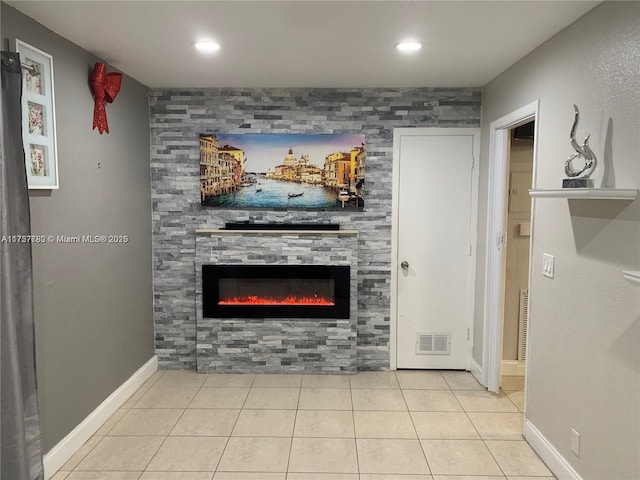 unfurnished living room featuring recessed lighting, visible vents, a large fireplace, baseboards, and tile patterned floors