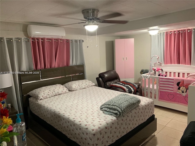 bedroom with an AC wall unit and tile patterned floors