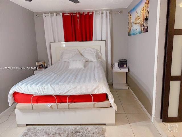 bedroom with tile patterned flooring and baseboards