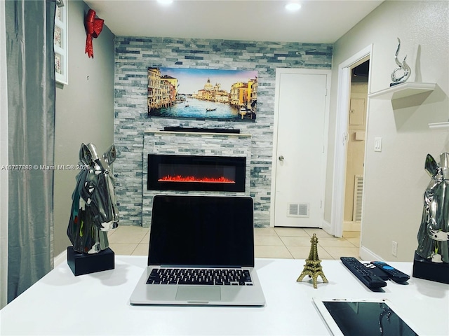 kitchen with a tile fireplace, visible vents, and light tile patterned flooring