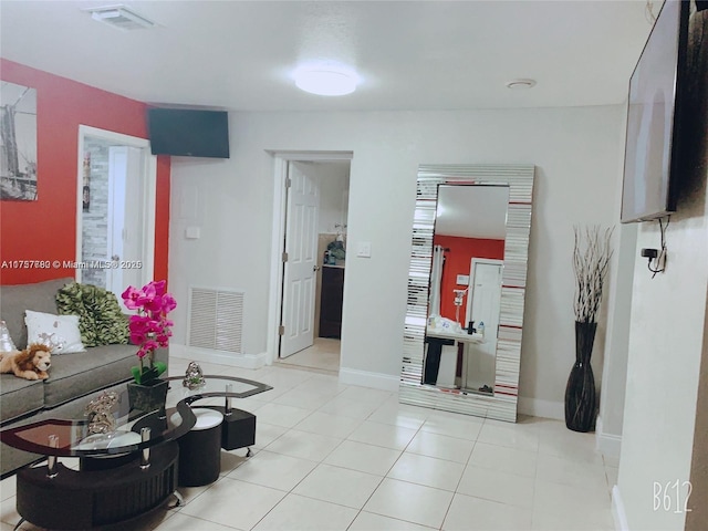 tiled living area featuring visible vents and baseboards