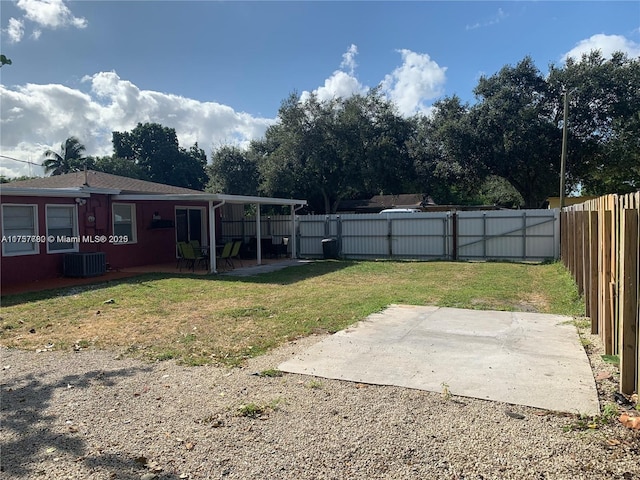 view of yard featuring central AC, a patio area, and a fenced backyard