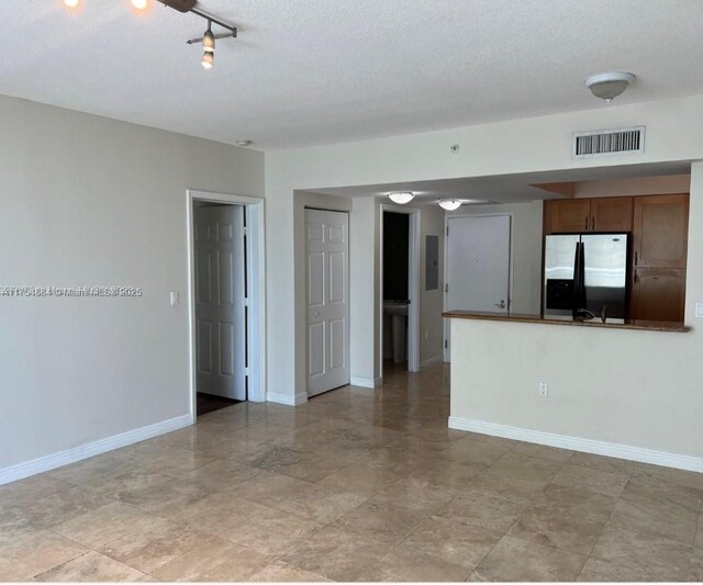 1745 E Hallandale Beach Blvd Unit 804W, Hallandale Beach, FL 33009 - unfurnished living room with baseboards and a textured ceiling