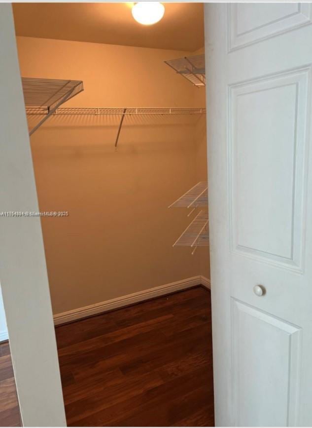 1745 E Hallandale Beach Blvd Unit 804W, Hallandale Beach, FL 33009 - walk in closet featuring dark wood-type flooring