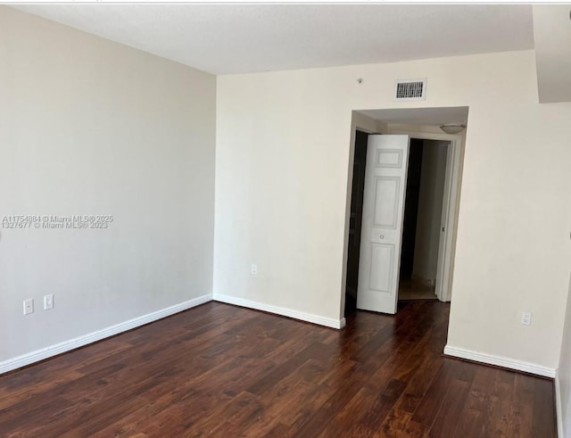 1745 E Hallandale Beach Blvd Unit 804W, Hallandale Beach, FL 33009 - spare room featuring dark wood-type flooring and baseboards