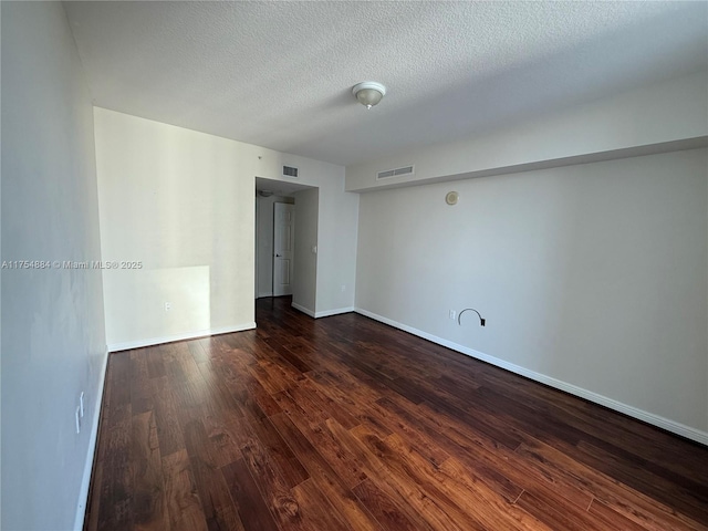 1745 E Hallandale Beach Blvd Unit 804W, Hallandale Beach, FL 33009 - empty room with dark wood-style flooring, a textured ceiling, and baseboards