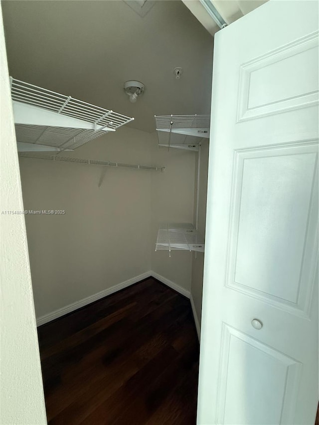 1745 E Hallandale Beach Blvd Unit 804W, Hallandale Beach, FL 33009 - walk in closet with dark wood-style floors