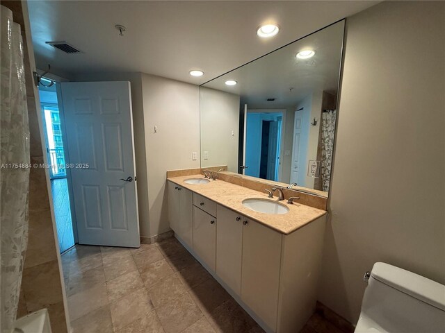 1745 E Hallandale Beach Blvd Unit 804W, Hallandale Beach, FL 33009 - bathroom with toilet, recessed lighting, double vanity, baseboards, and a shower with curtain