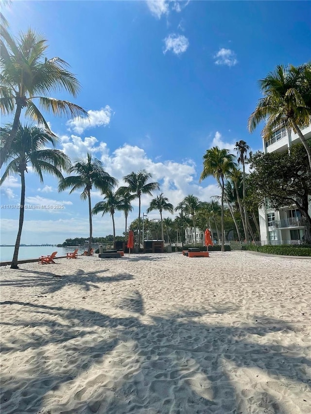 surrounding community featuring a water view and volleyball court