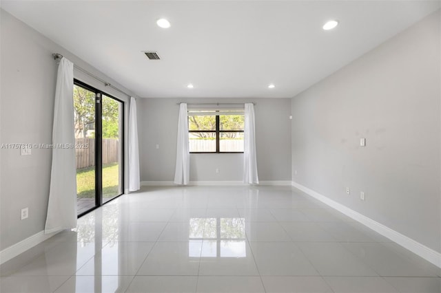 unfurnished room with light tile patterned floors, visible vents, baseboards, and recessed lighting