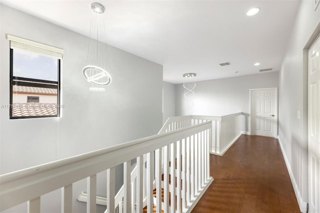 hall featuring recessed lighting, wood finished floors, visible vents, and an inviting chandelier