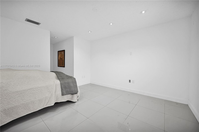 tiled bedroom with recessed lighting, visible vents, and baseboards