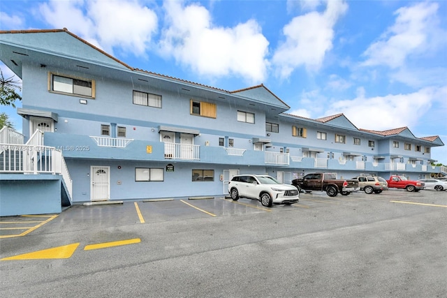 view of building exterior featuring uncovered parking