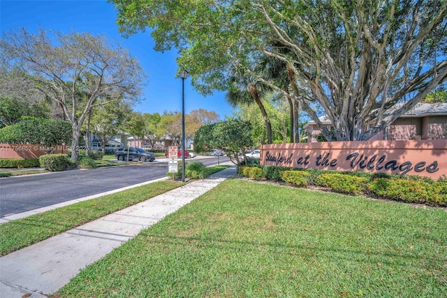 view of street with sidewalks, curbs, and street lights