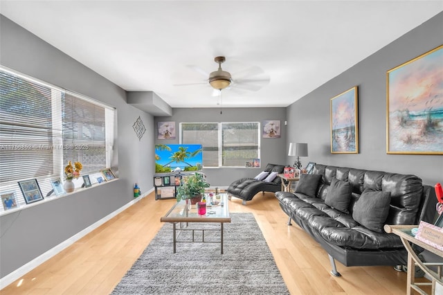 living area featuring ceiling fan, wood finished floors, and baseboards