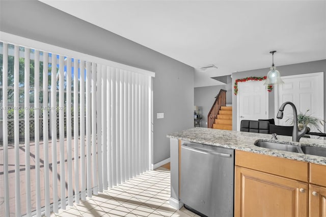 kitchen featuring visible vents, dishwasher, light stone counters, pendant lighting, and a sink