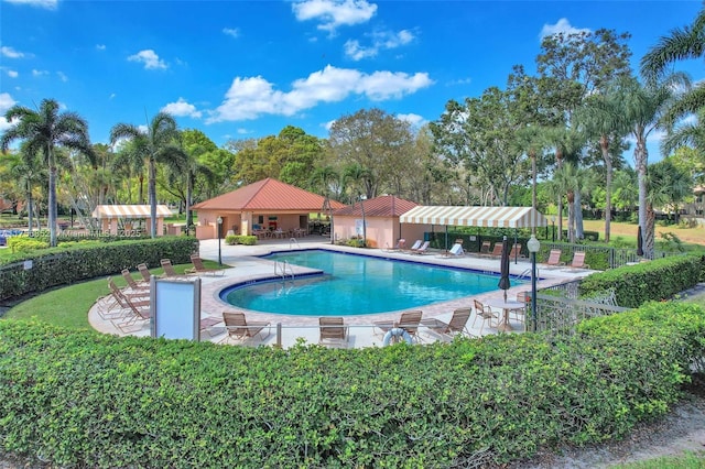 community pool featuring a gazebo, a patio, and fence