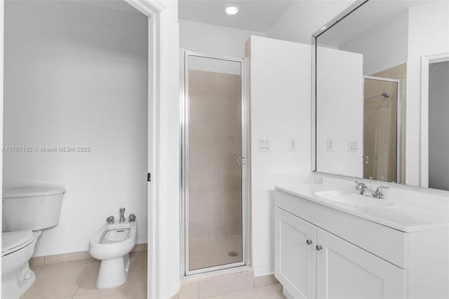 bathroom with toilet, tile patterned floors, vanity, a shower stall, and a bidet