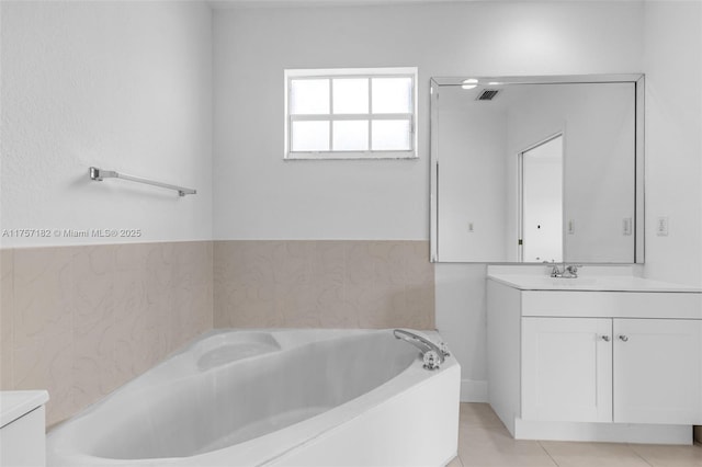 bathroom with tile patterned floors, visible vents, vanity, and a bath