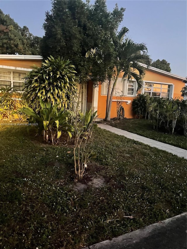 view of front of property with a front lawn and stucco siding