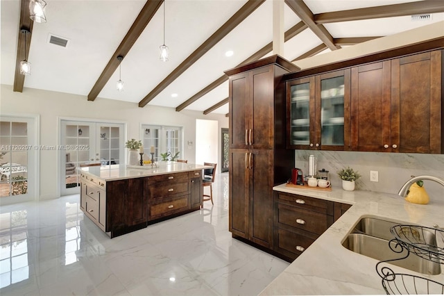 kitchen with lofted ceiling with beams, a sink, marble finish floor, french doors, and tasteful backsplash