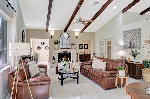 living room featuring visible vents, a fireplace with raised hearth, beamed ceiling, french doors, and high vaulted ceiling