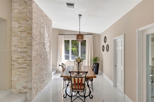 dining space featuring a textured ceiling, visible vents, baseboards, vaulted ceiling, and marble finish floor