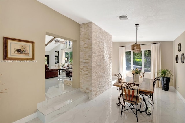 dining room with baseboards, visible vents, marble finish floor, vaulted ceiling, and a textured ceiling