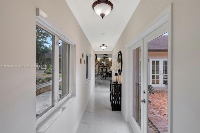 corridor featuring marble finish floor, crown molding, and french doors