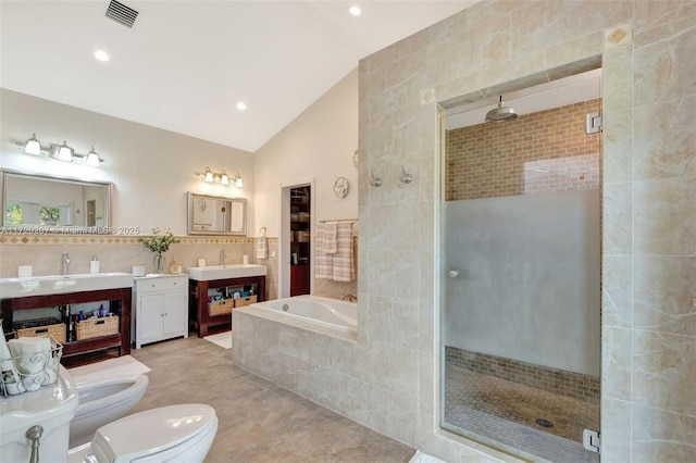 full bathroom with a garden tub, visible vents, a stall shower, vaulted ceiling, and vanity