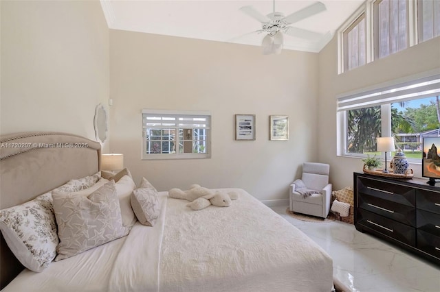 bedroom featuring ceiling fan, marble finish floor, and baseboards