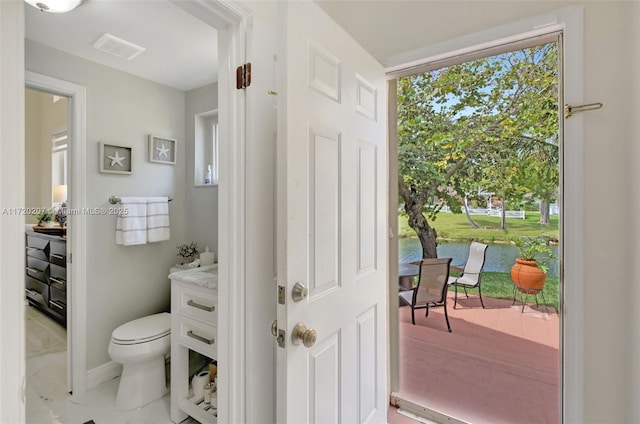 bathroom featuring toilet, visible vents, and vanity